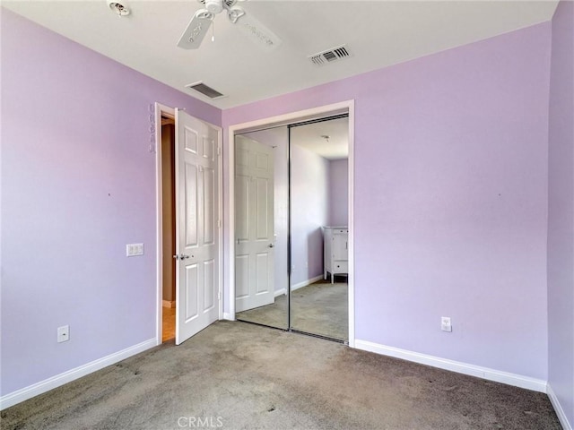 unfurnished bedroom featuring ceiling fan, a closet, and carpet floors