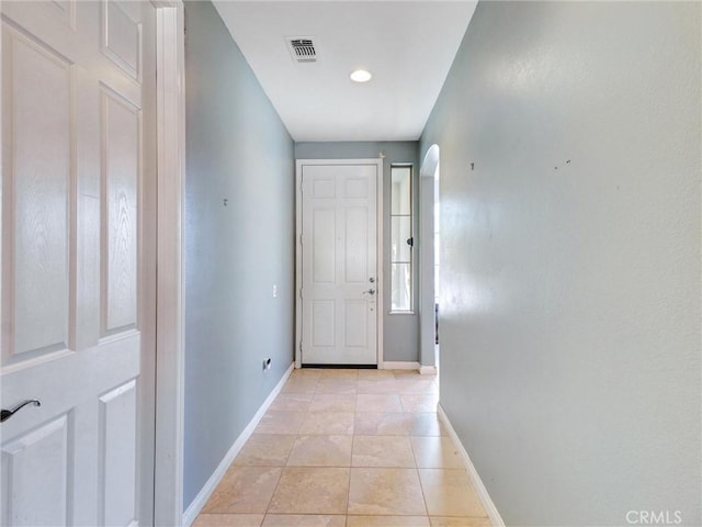 doorway to outside with light tile patterned floors