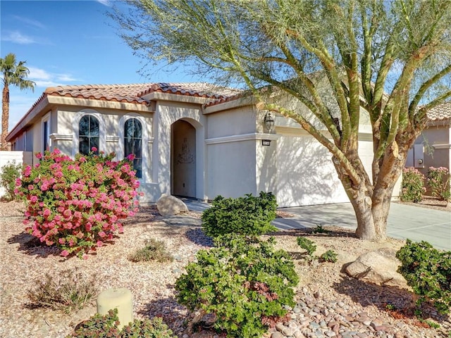 mediterranean / spanish-style home with a garage