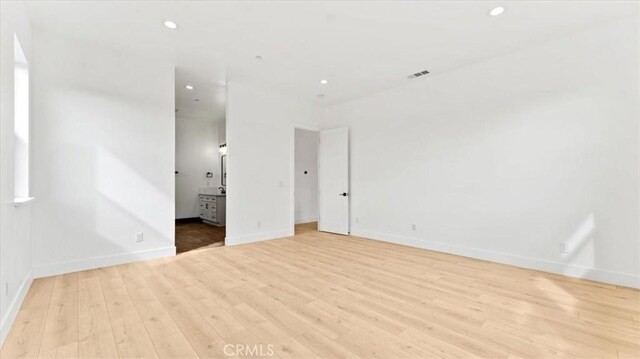 unfurnished room with light hardwood / wood-style floors