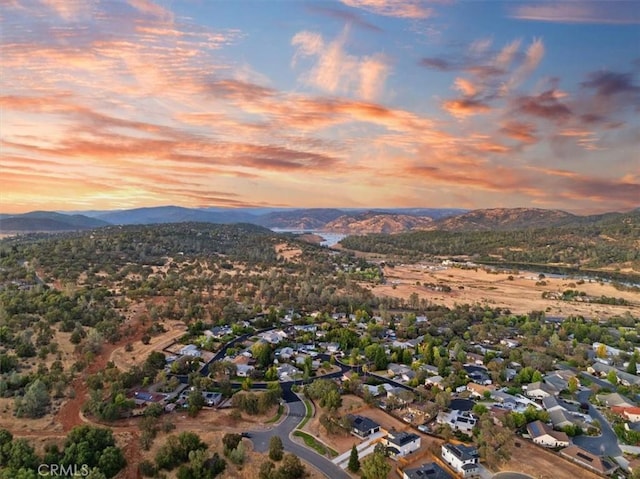 aerial view at dusk featuring a mountain view