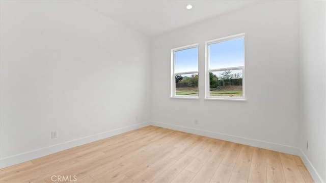 spare room featuring light wood-type flooring