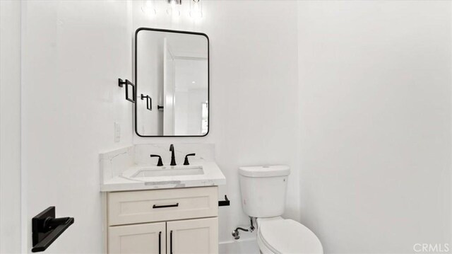 bathroom with toilet and vanity