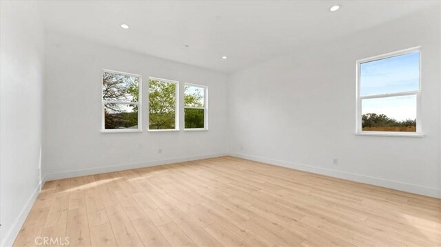 spare room with light wood-type flooring