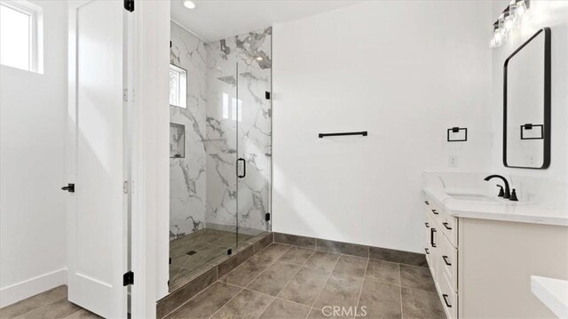 bathroom with an enclosed shower and vanity