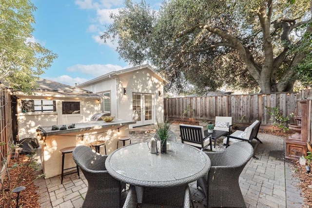 view of patio with exterior bar and french doors