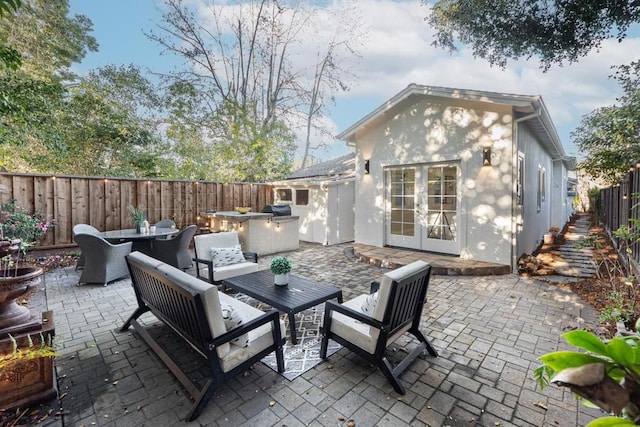 view of patio featuring french doors and an outdoor living space