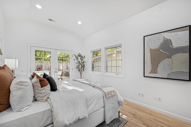 bedroom with access to exterior, french doors, light hardwood / wood-style flooring, and lofted ceiling