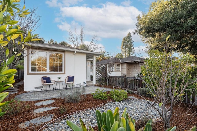 back of house with a patio