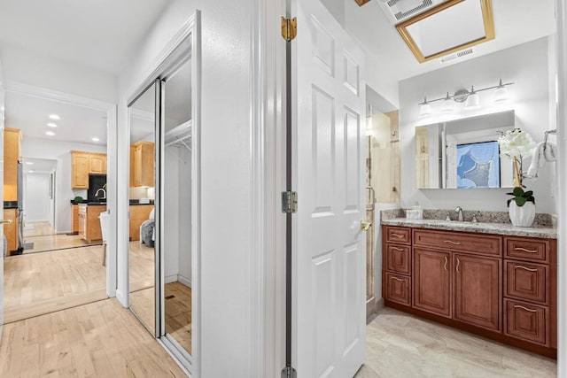 bathroom with vanity and wood-type flooring