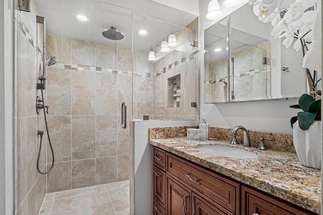 bathroom featuring vanity and a shower with shower door