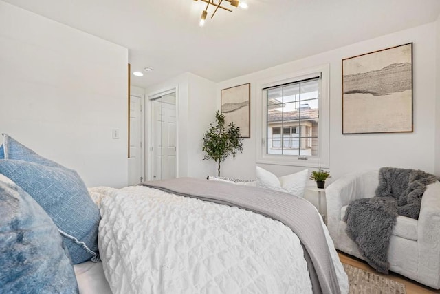 bedroom featuring an inviting chandelier and a closet