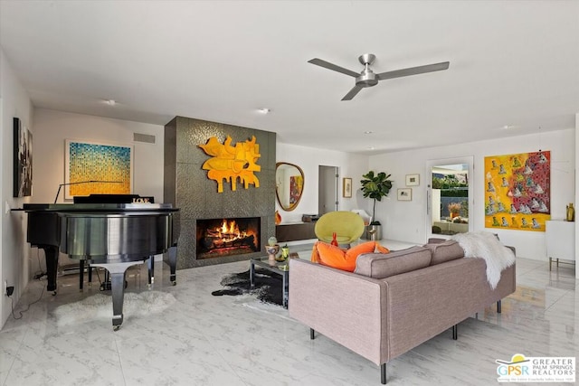 living room with ceiling fan and a fireplace