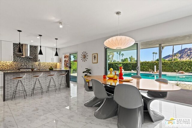 dining room featuring a mountain view and sink