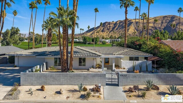 view of front of property featuring a garage and a mountain view