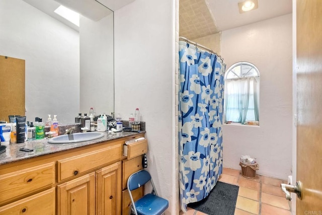 bathroom with vanity, a shower with shower curtain, and tile patterned flooring