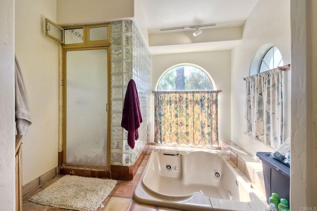 bathroom featuring independent shower and bath