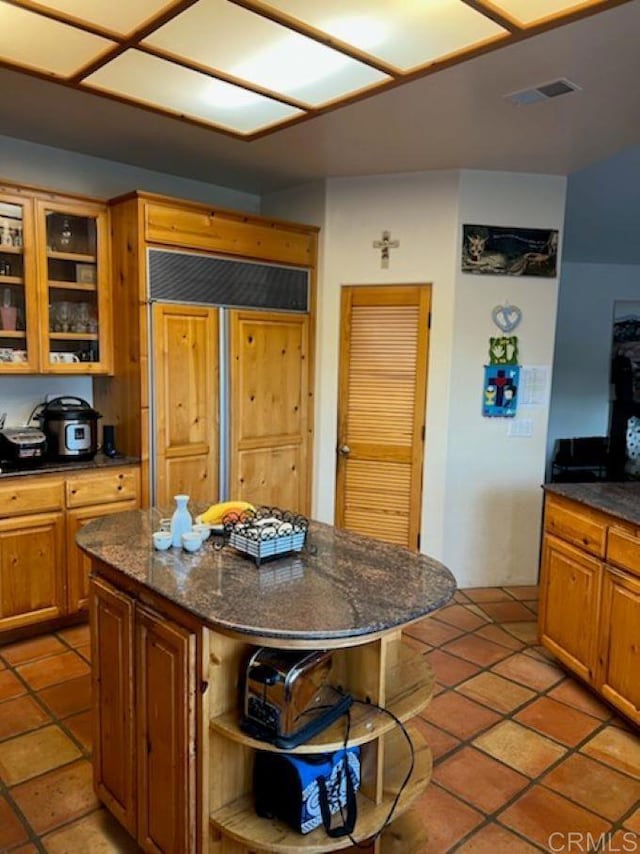 kitchen featuring a kitchen island and paneled fridge