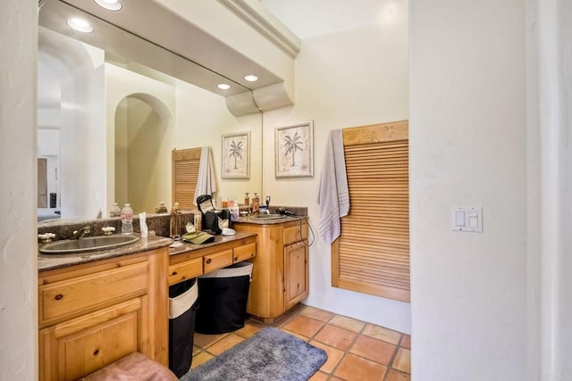 bathroom with tile patterned flooring and vanity