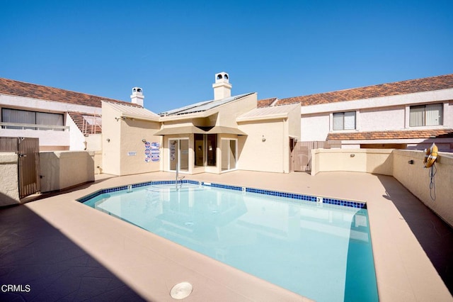 rear view of house featuring a patio area and a community pool