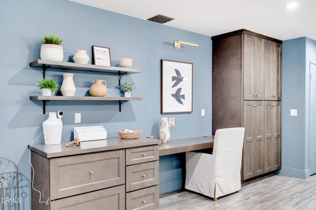 office area featuring built in desk and light hardwood / wood-style floors