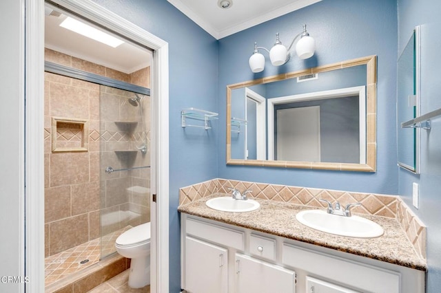 bathroom featuring a shower with door, vanity, decorative backsplash, toilet, and crown molding