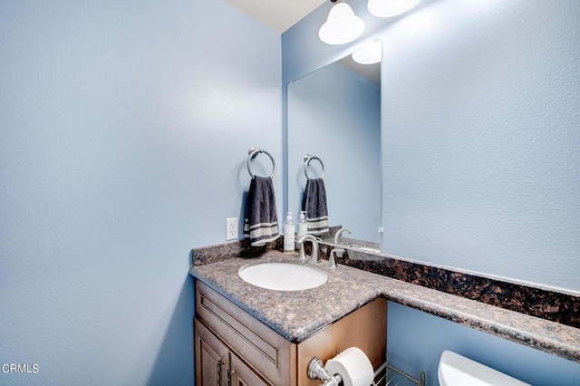 bathroom featuring toilet and vanity