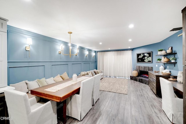 dining area featuring light hardwood / wood-style floors and a fireplace