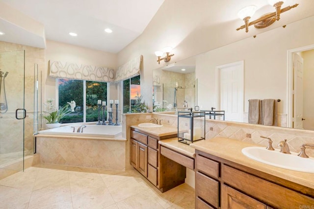 bathroom featuring tile patterned flooring, vanity, and shower with separate bathtub