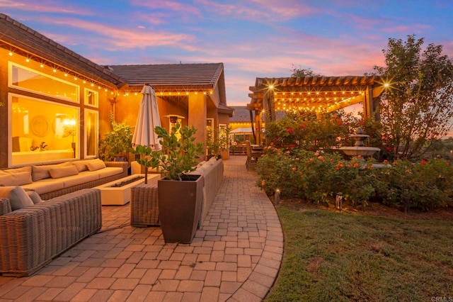 patio terrace at dusk featuring an outdoor hangout area