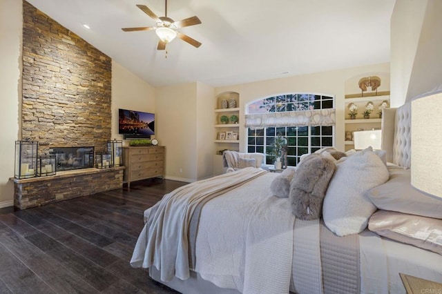 bedroom with ceiling fan, dark hardwood / wood-style flooring, lofted ceiling, and a fireplace