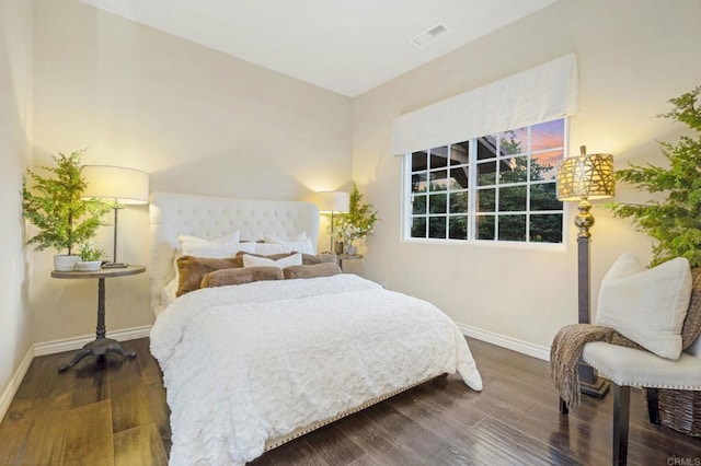 bedroom with dark wood-type flooring