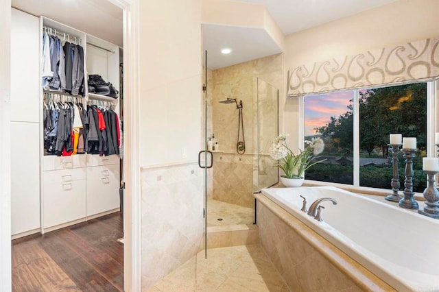 bathroom featuring shower with separate bathtub and hardwood / wood-style floors