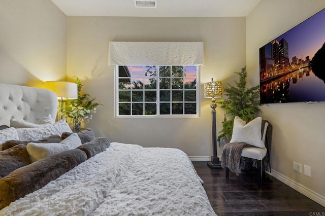 bedroom with dark hardwood / wood-style floors