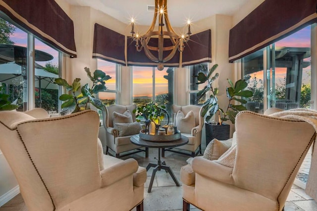 sunroom / solarium with plenty of natural light and a notable chandelier