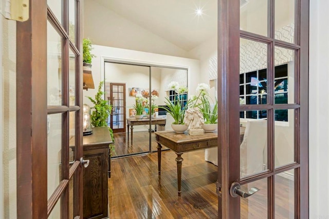 interior space featuring french doors, vaulted ceiling, and hardwood / wood-style flooring