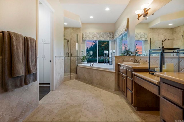 bathroom with vanity and independent shower and bath