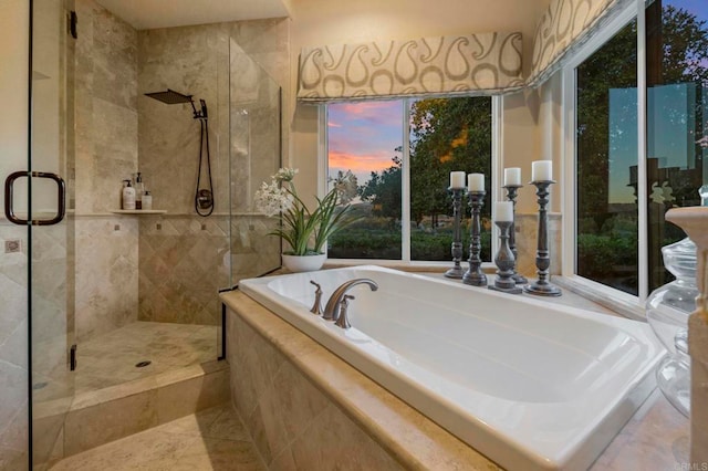 bathroom featuring separate shower and tub