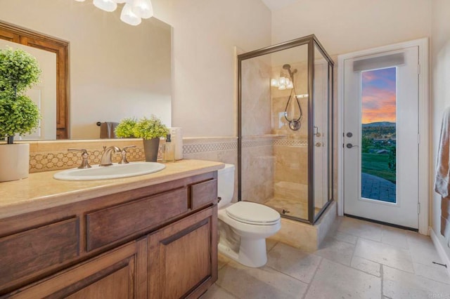 bathroom featuring walk in shower, vanity, and toilet