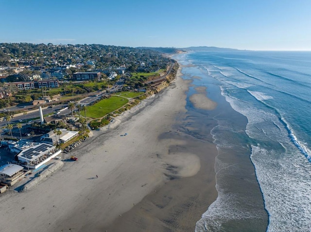 birds eye view of property with a water view and a view of the beach