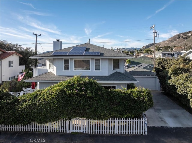 view of front of property with a garage and solar panels