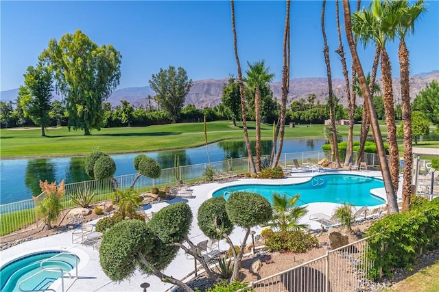 view of swimming pool with a water and mountain view, a patio, and a community hot tub