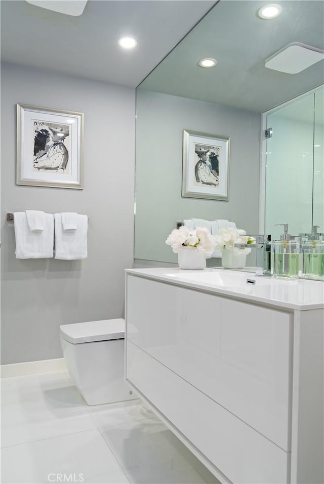 bathroom with tile patterned floors, vanity, and toilet