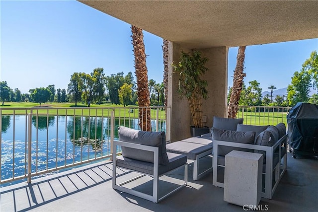 balcony featuring a water view and a grill