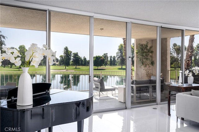 doorway to outside with tile patterned flooring, a water view, and a wall of windows