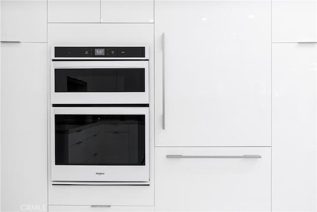 interior details featuring white cabinetry and double wall oven