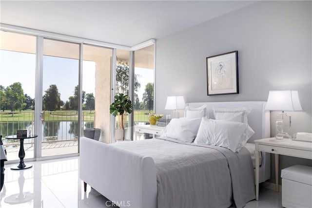 bedroom with access to exterior, floor to ceiling windows, a water view, and tile patterned floors