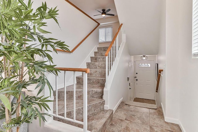 foyer entrance with ceiling fan