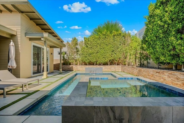 view of swimming pool featuring pool water feature, a patio area, and an in ground hot tub