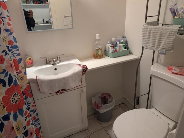 bathroom featuring toilet, tile patterned flooring, and vanity